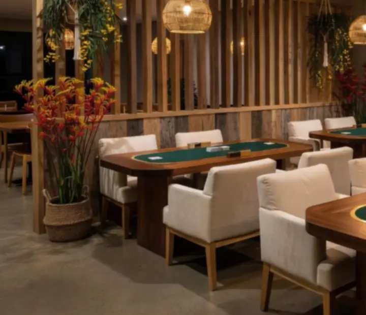 Card Lounge interior at ADSIGHT LTD with timber poker tables, soft lighting and lounge seating.